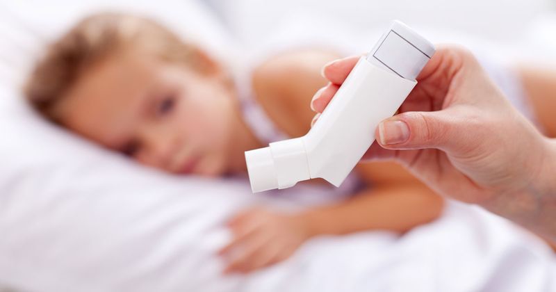 Asthma inhaler with child in background