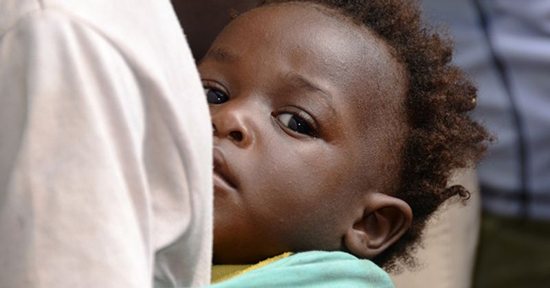 Black infant being breastfed