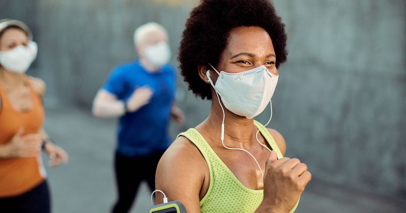 Black woman wearing mask while exercising