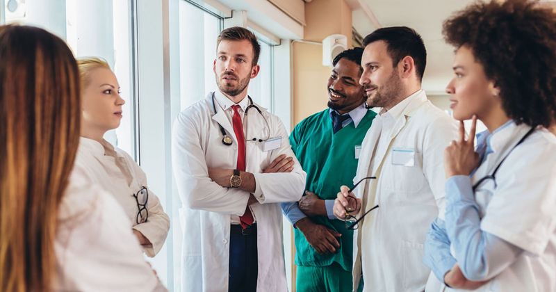 Diverse group of health care professionals talking