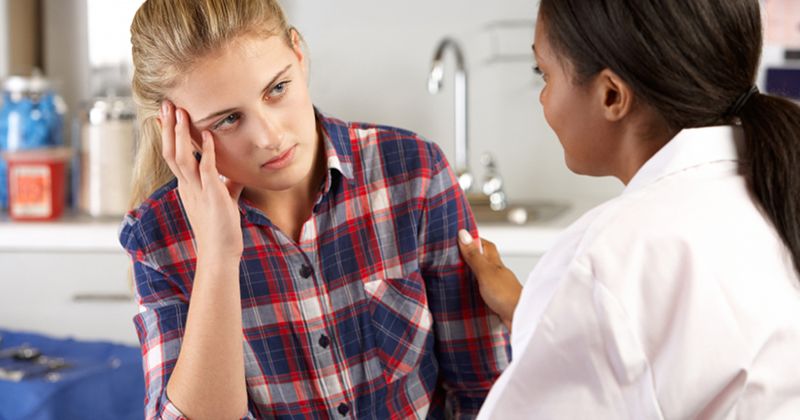 Doctor and Young Female Patient Talking