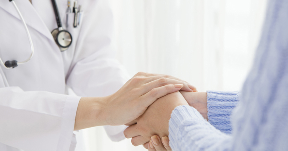 doctor holding a patient's hands