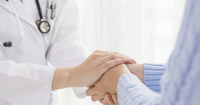 Doctor holding a patient's hands