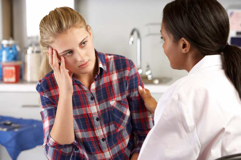 Doctor Talking to Young Patient