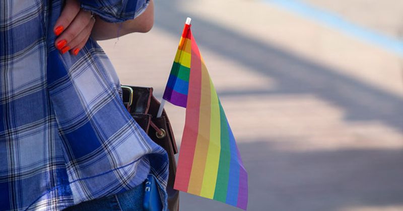 LGBTQ flag in woman's pants pocket