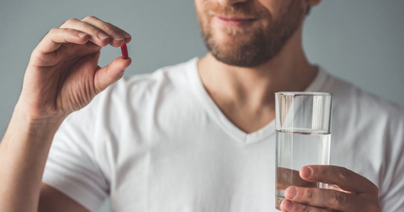 Man Taking Some Sort of Pill