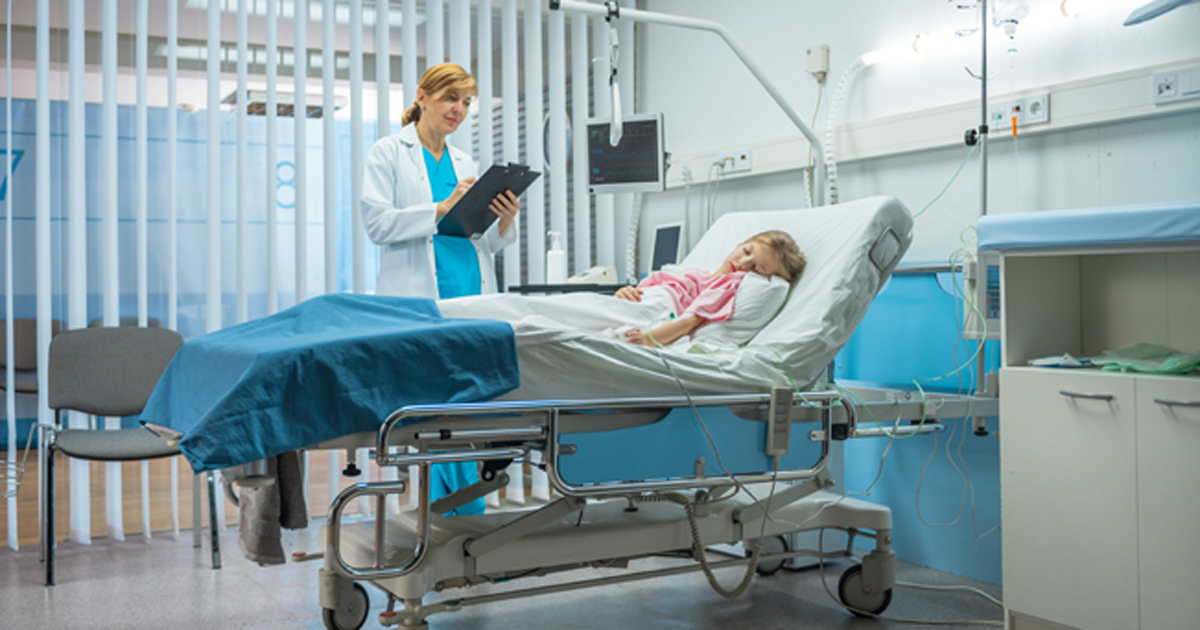 nurse at child's bedside in hospital