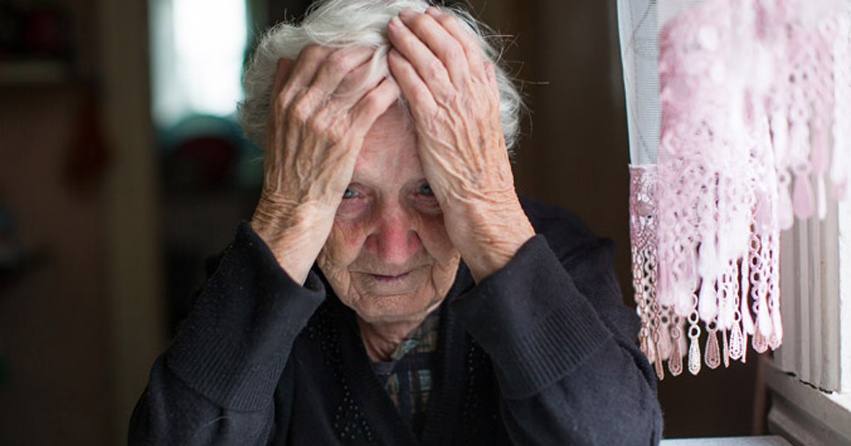 old woman with head in hands