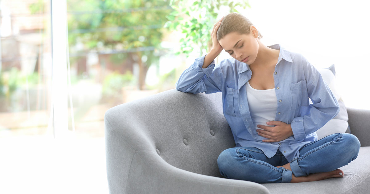 Woman with pain in stomach such as from endo or cramps