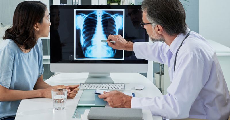 doctor showing patient x-ray