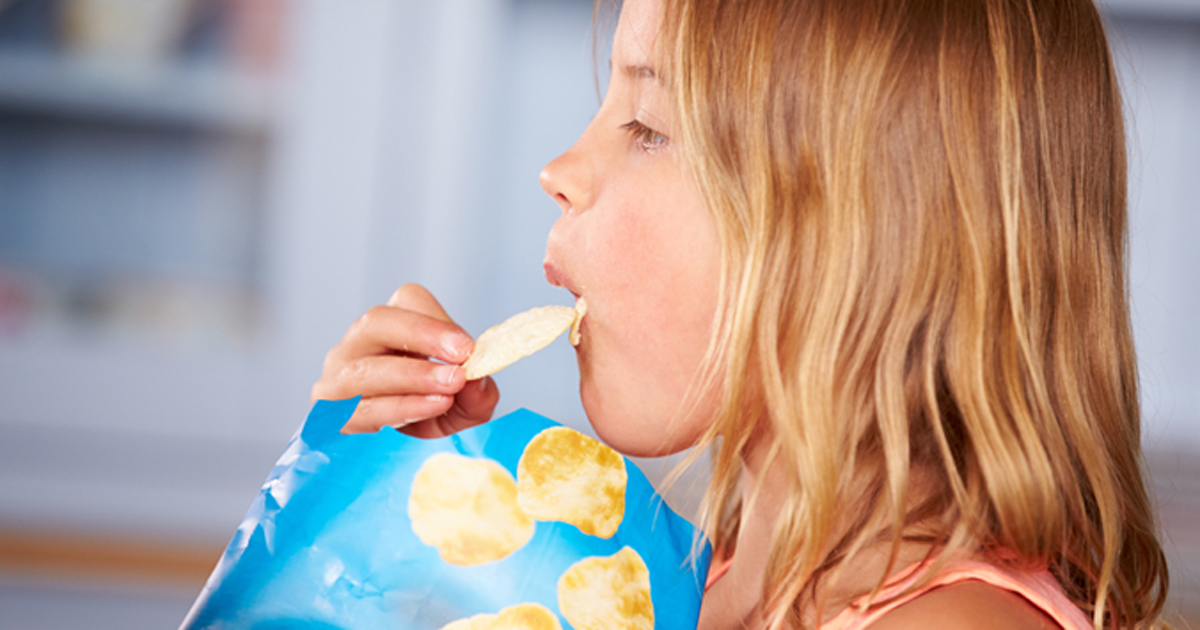 Child eating potato chips