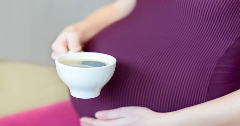 Pregnant Woman Holding a Hot Beverage