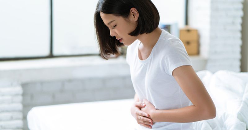 Woman grabbing stomach