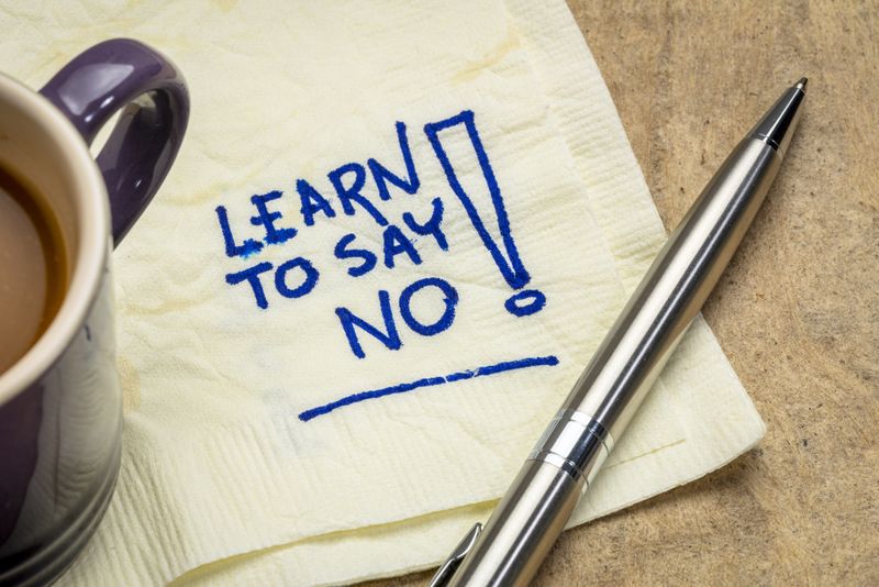 "Learn to say no" message written on a napkin.