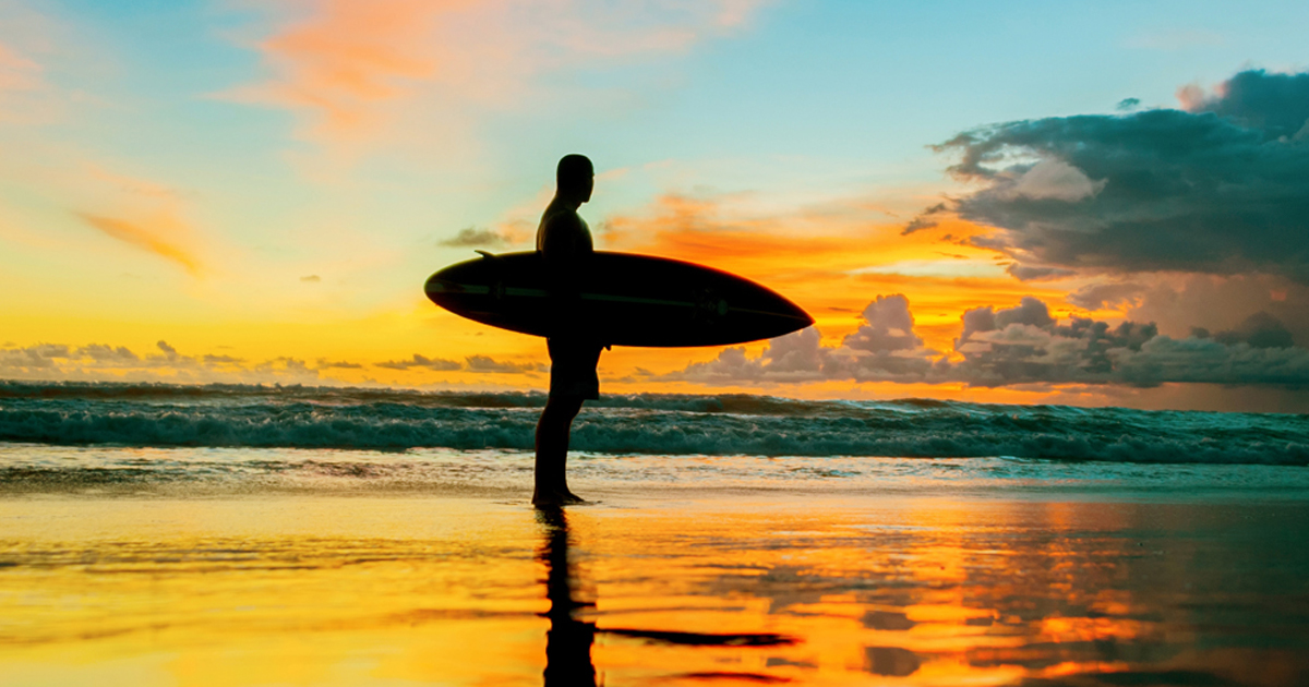 Photo of surfer during sunset