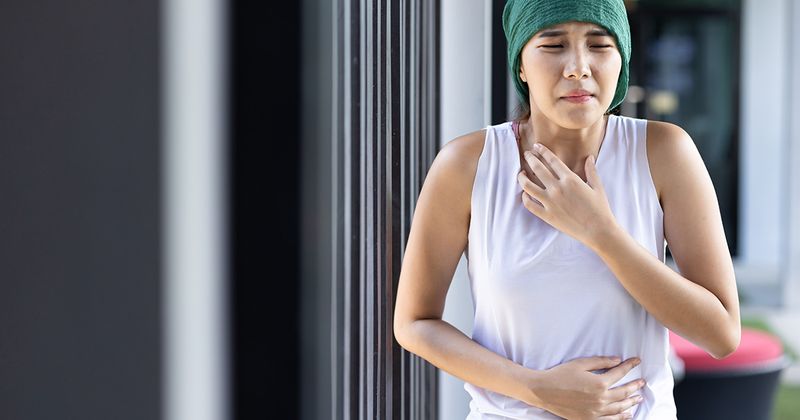 stock image of woman with cancer experiencing nausea