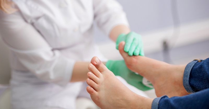 Photo of a doctor checking a patient's foot