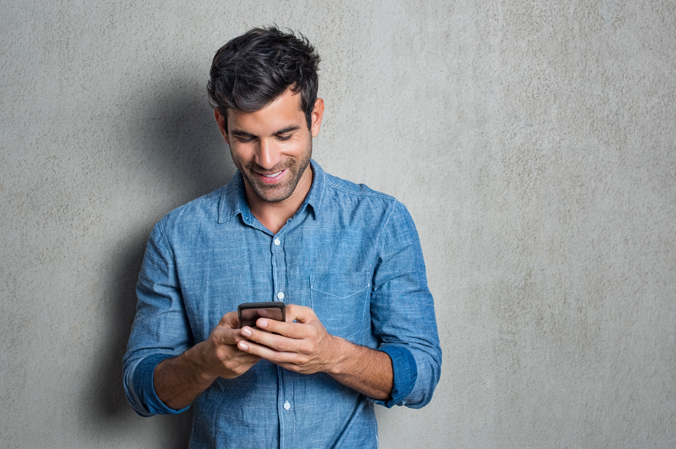 A photo of a man using a cell phone