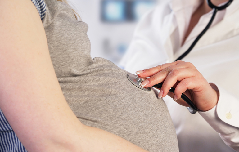 A photo of a pregnant woman getting a check-up