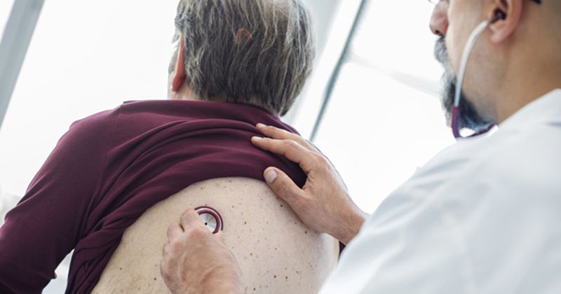 Image of man having a respiratory exam. 