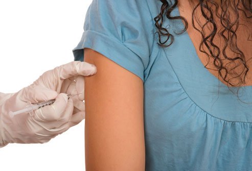 Image of a girl getting a vaccine. 