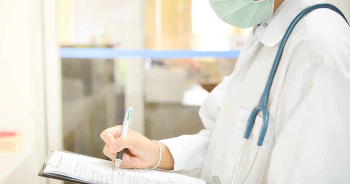 doctor looking at clipboard