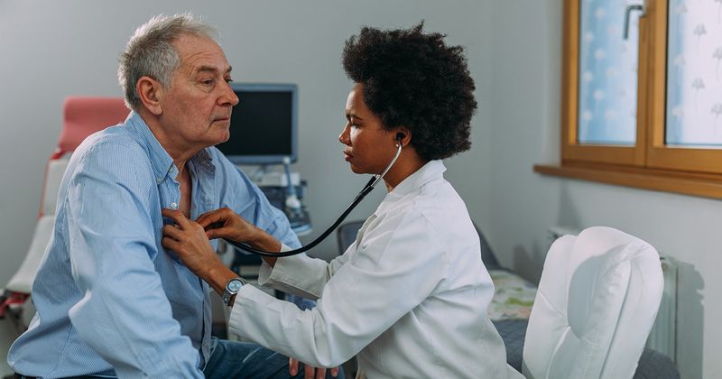 Dr. examining a senior patient