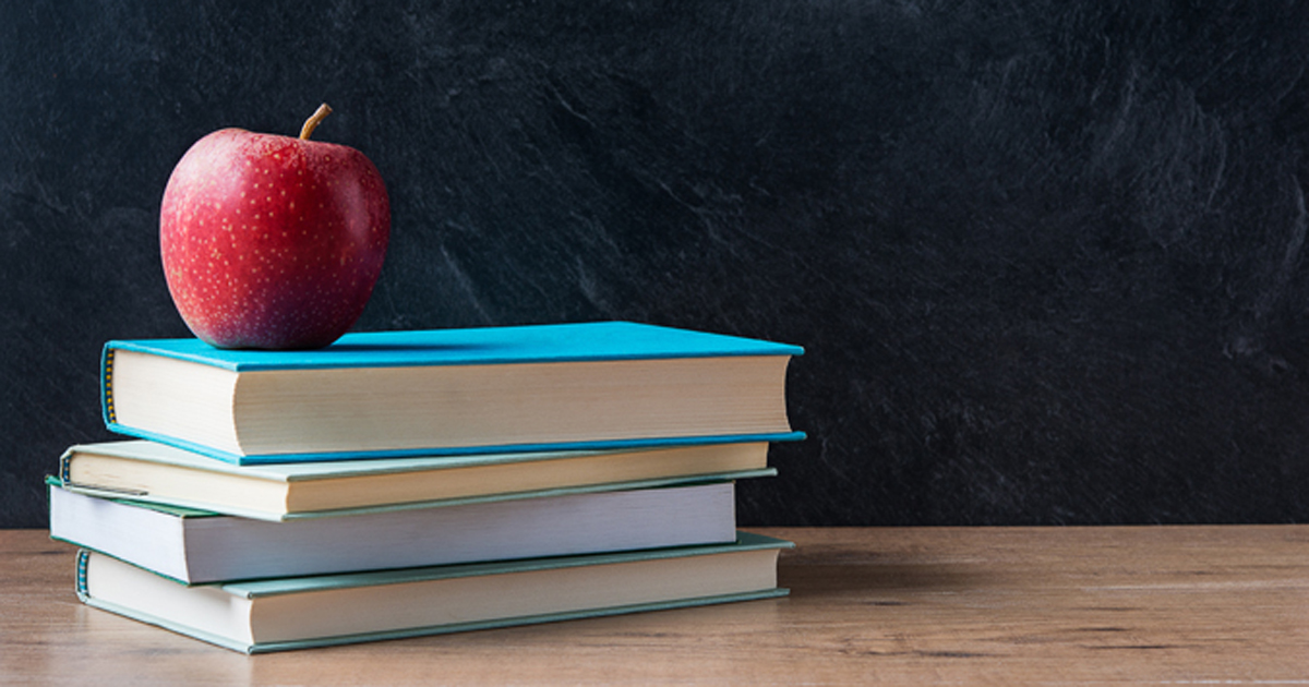 Stack of books with an apple on top