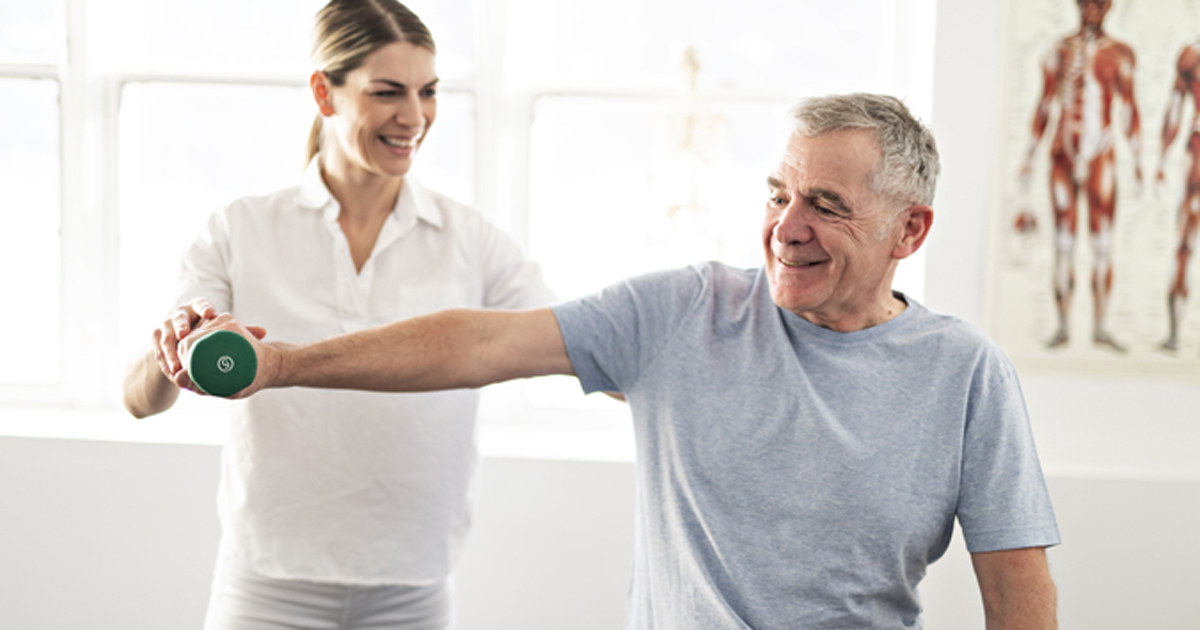 Man being assisted in lifting weights