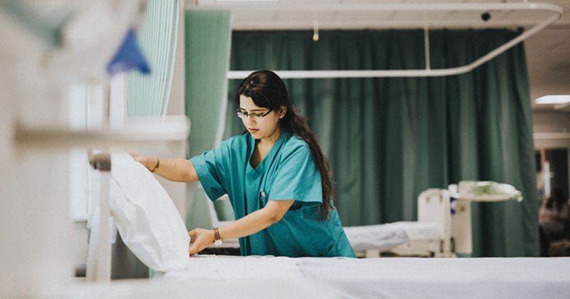 Nurse making bed