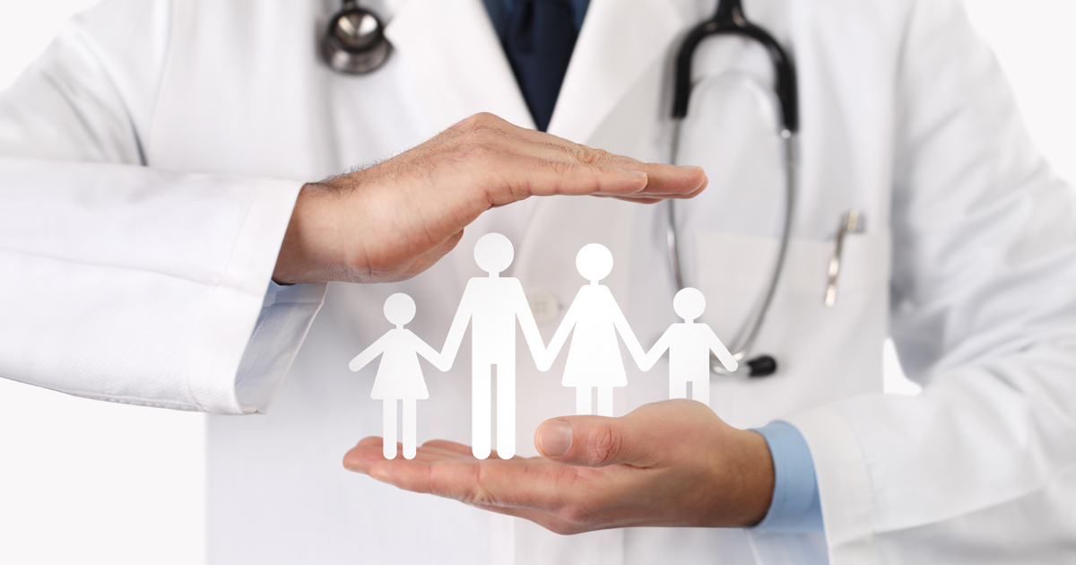 Doctor holding paper cut outs of family members