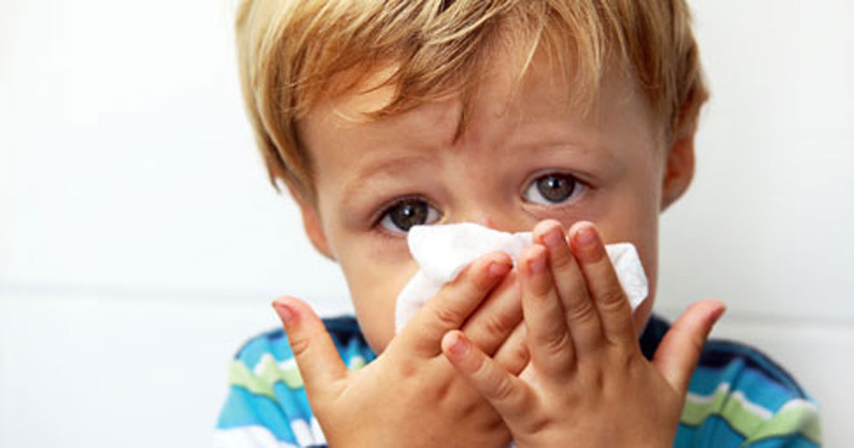 Boy blowing nose