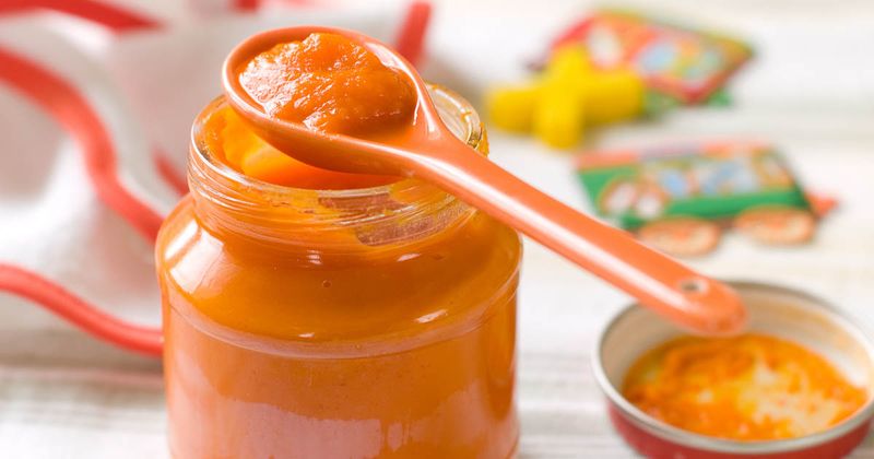 Jar of baby food with spoon