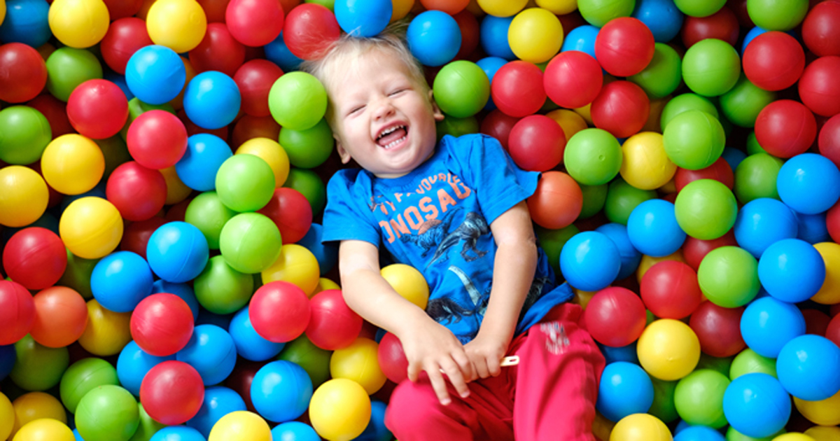 Boy playing in ball pit