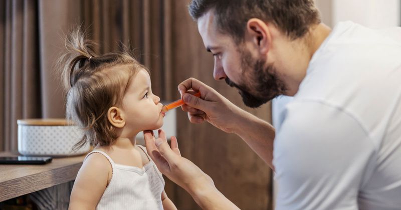 Father gives baby girl medicine