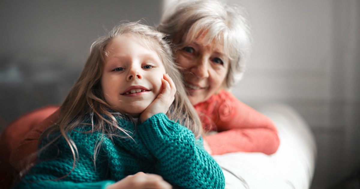 Grandmother sitting on couch with grandchild