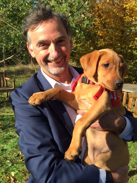 Researcher holding medical detection puppy