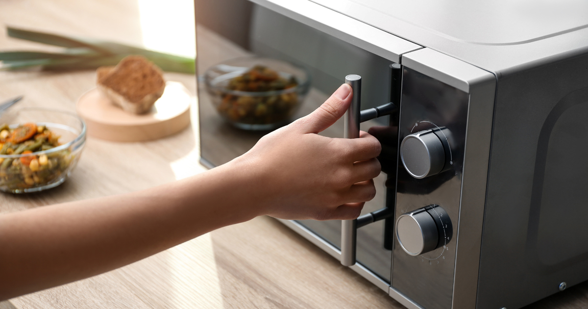 Photo of a child opening a microwave door