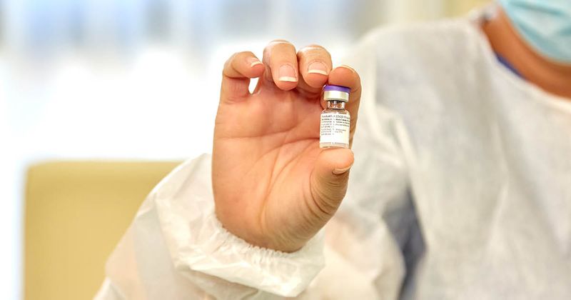 Pfizer vial in hand