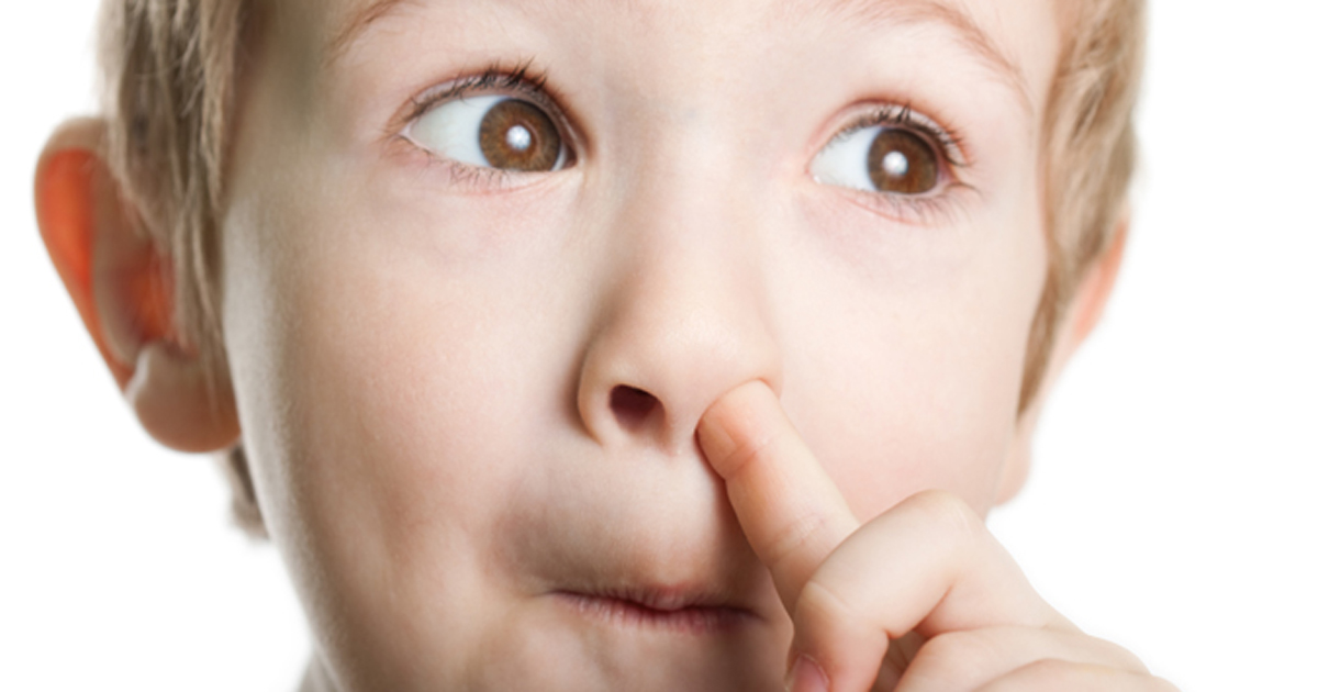 Young boy picking his nose