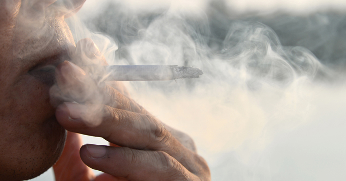 Photo of man smoking a cigarette