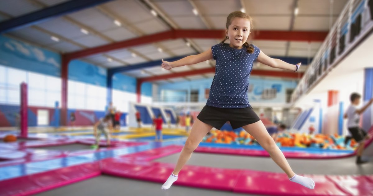 Young girl jumping on trampoline at trampoline park