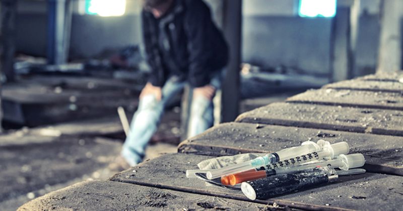 iv drugs on table with man in background