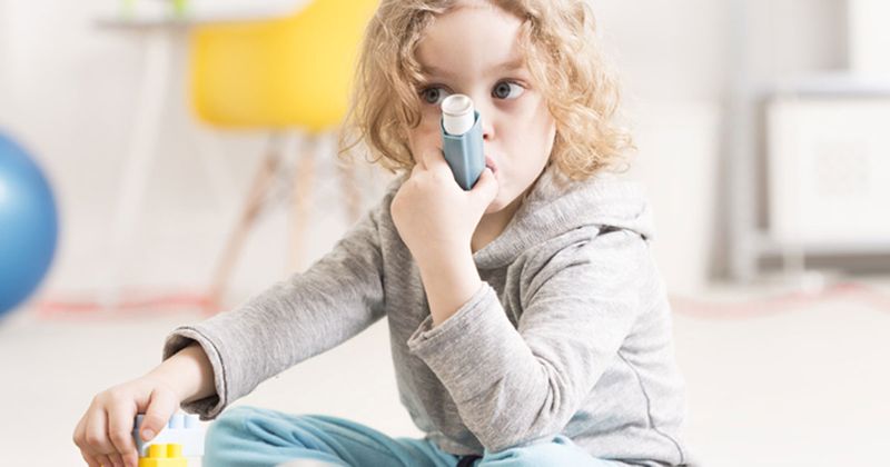 Child with an asthma inhaler