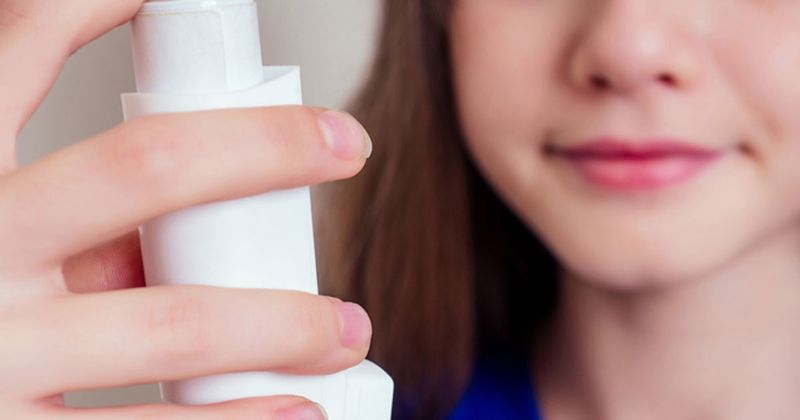 Teen with an asthma inhaler