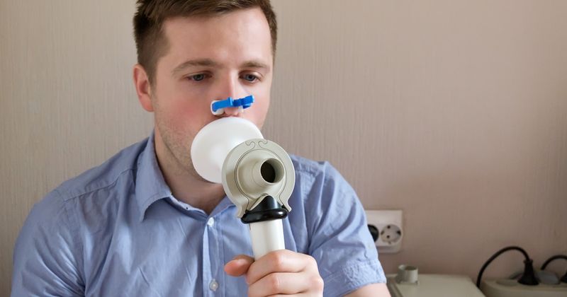 Man testing breathing function by spirometry