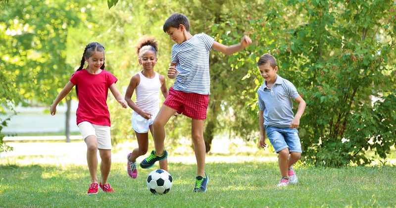 Children playing soccer outside