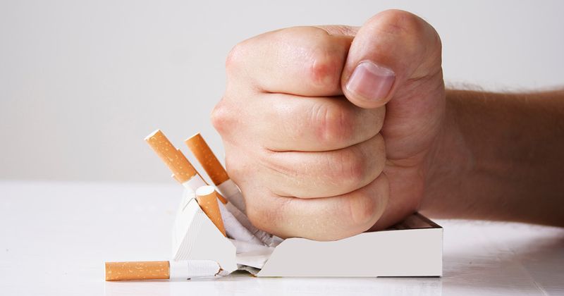 Hand crushing cigarettes