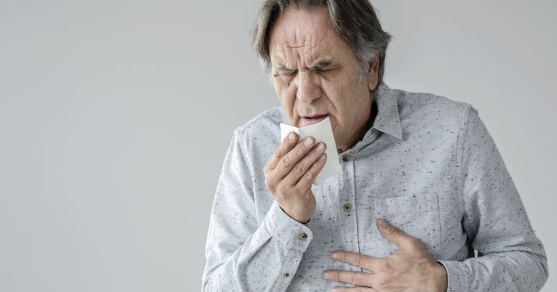 Older man coughing