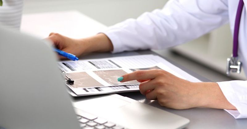 Doctor reviewing medical chart_Shutterstock